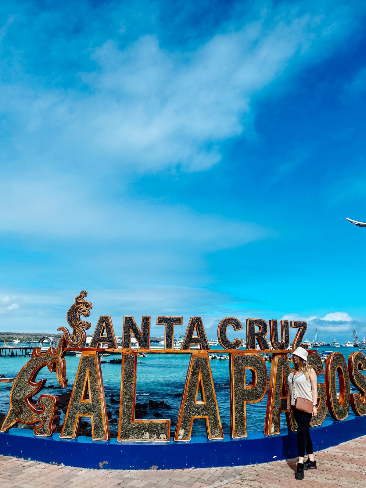 Tourist at the Santa Cruz Galápagos waterfront featured in our agency’s guide to cheaper island stays and cruise options