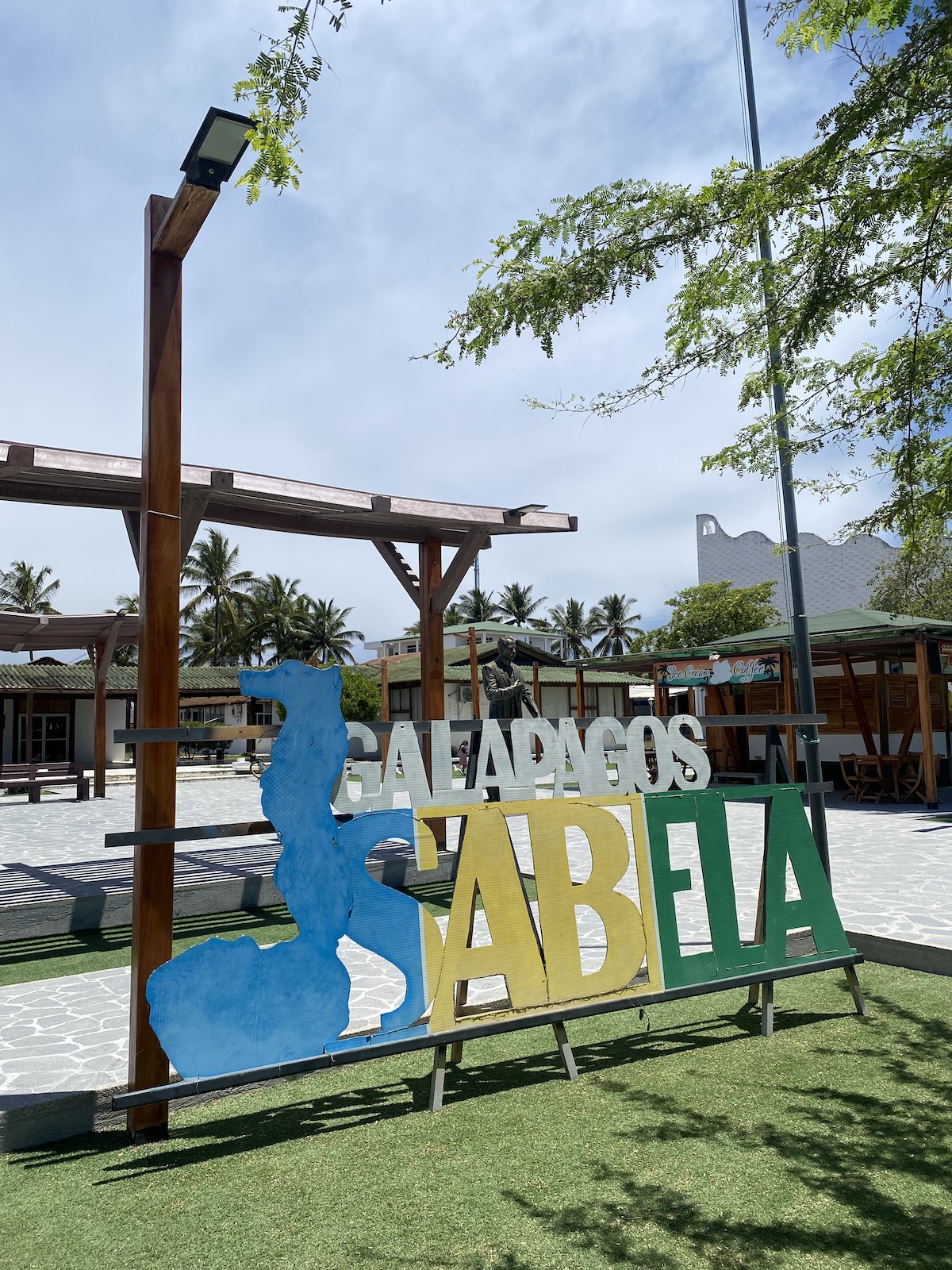 Isabela Island landmark sign surrounded by tropical scenery during a Galapagos cruise adventure with Cruises to Galapagos Islands